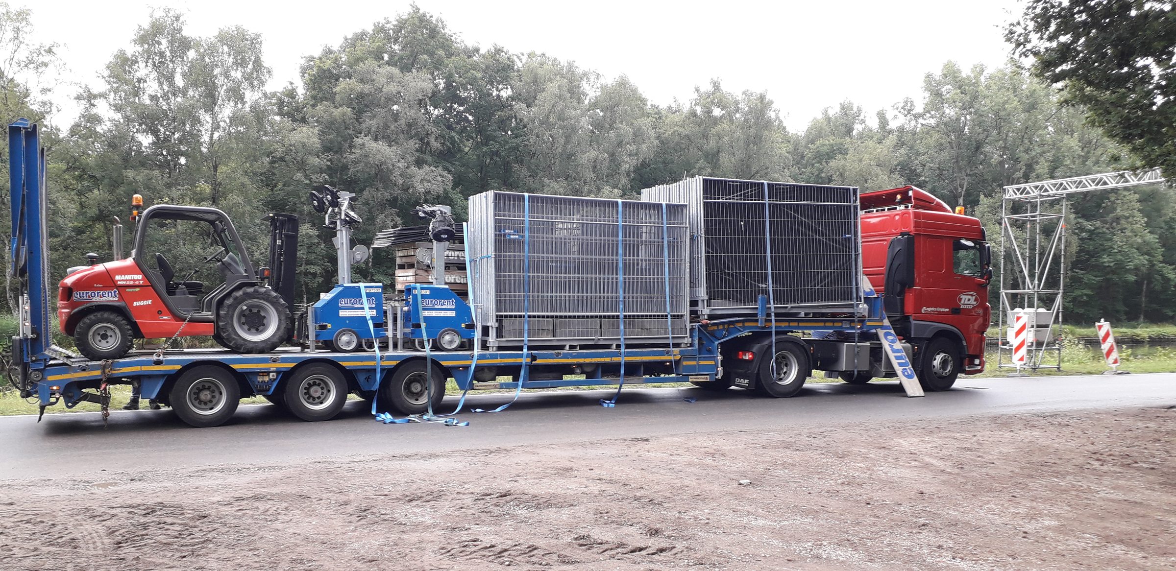 Trailer with fencing and forklift on the way to the site