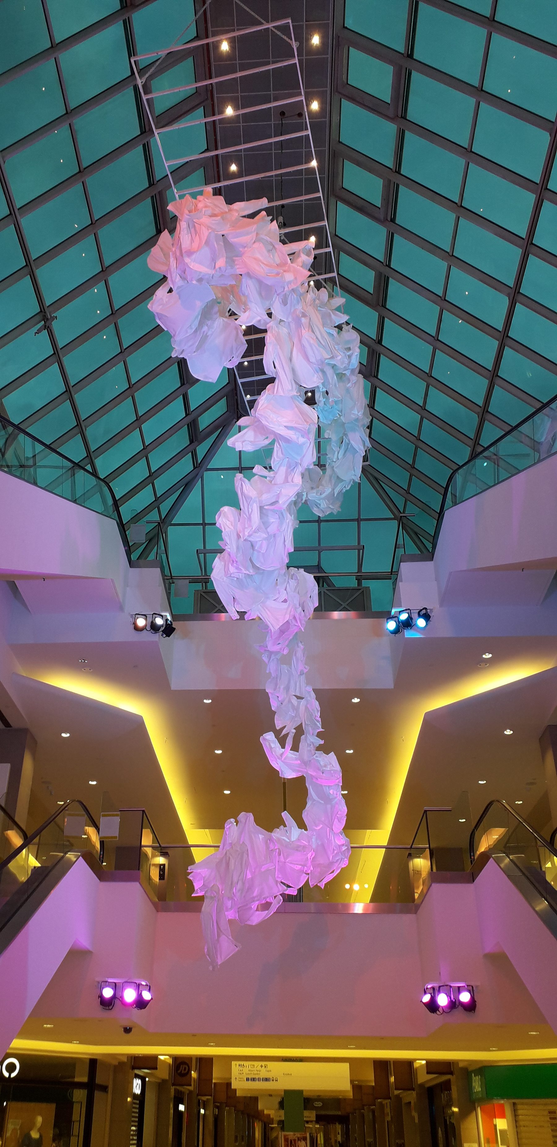 The textile installation above the escalators, lit