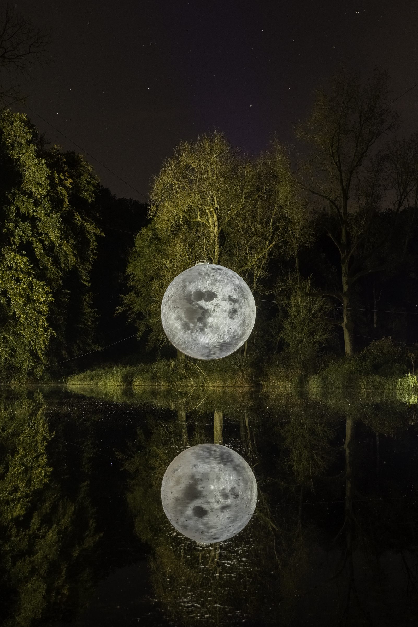 Moon installation reflected in the water
