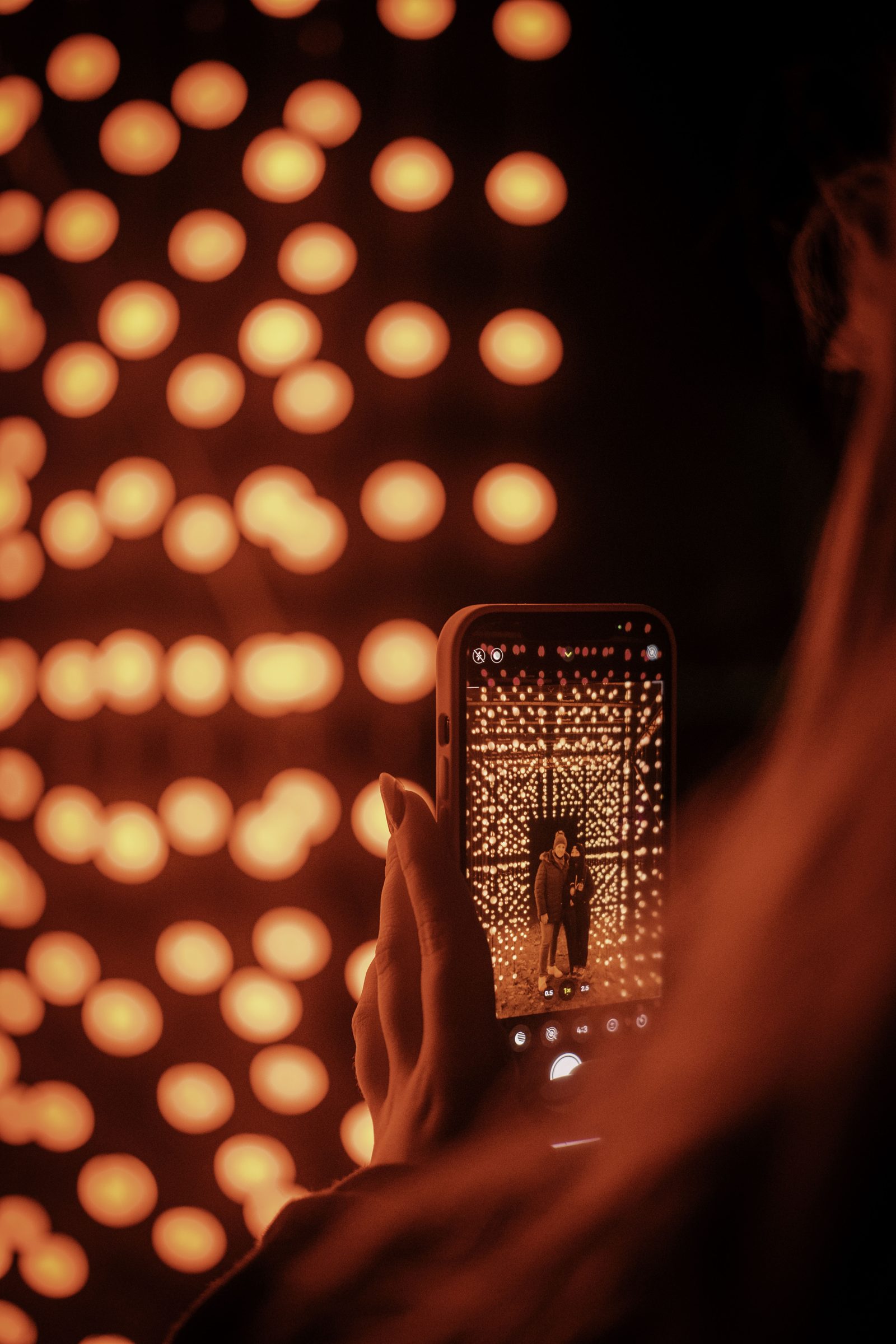 Visitor inside a red light installation