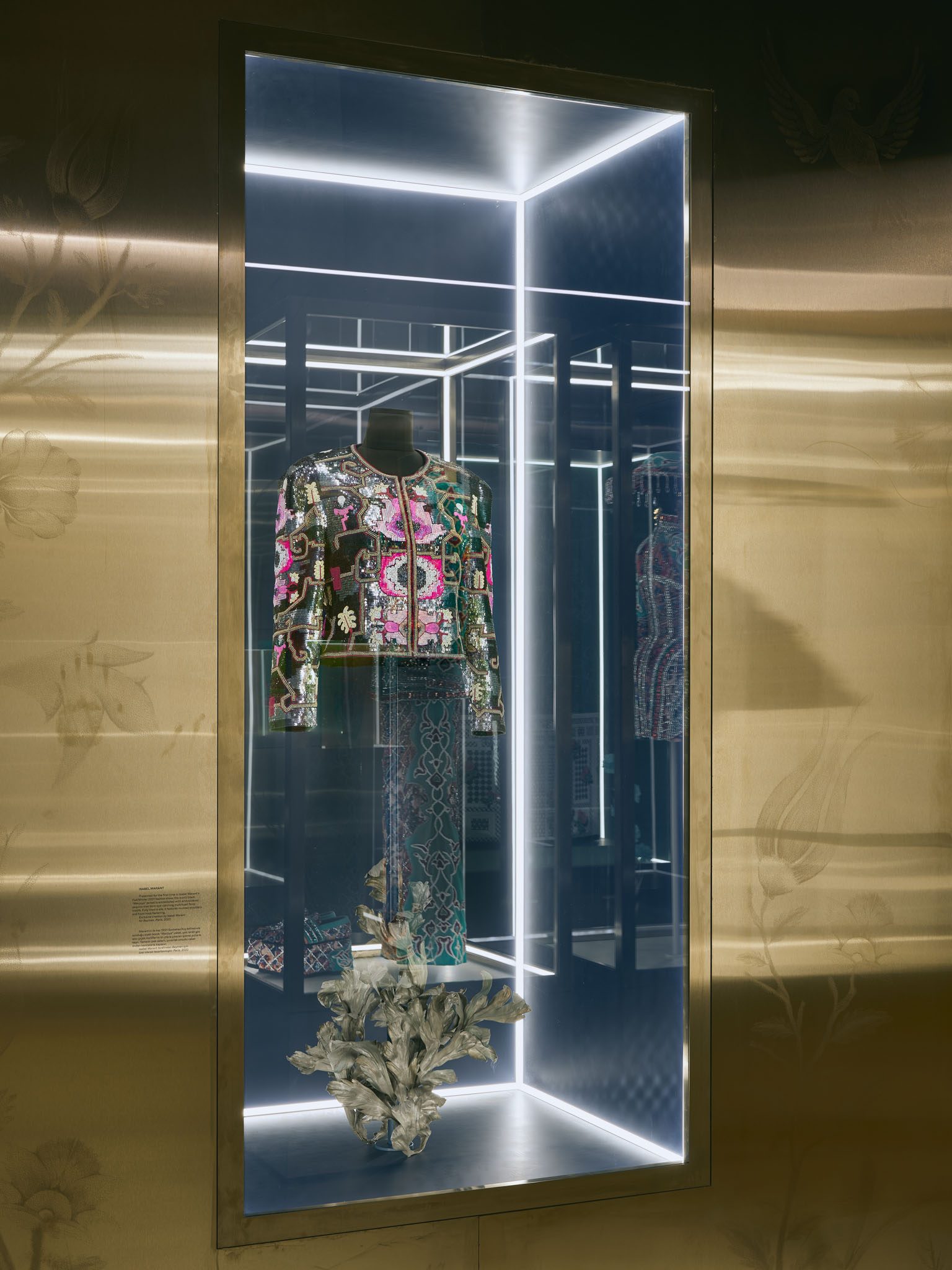 Embroidered garment in a display case