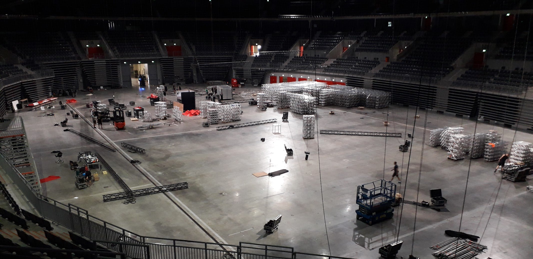 Empty arena floor with stacked truss material