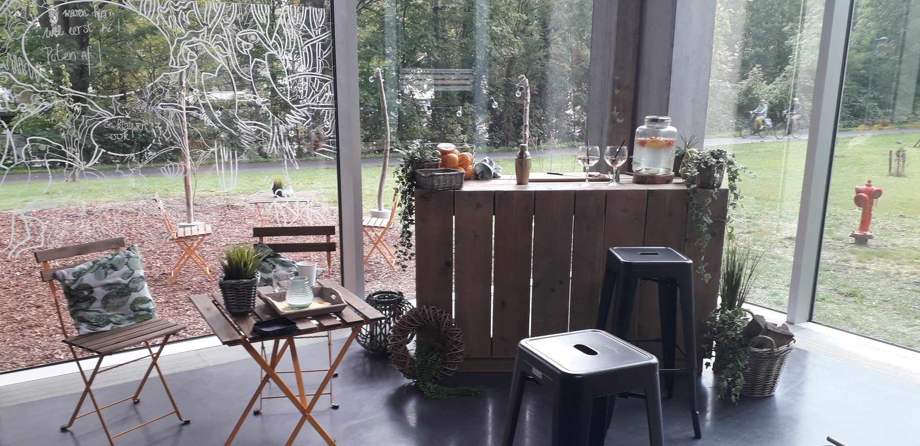 Scaffold-wood cocktail bar in a glass pavilion