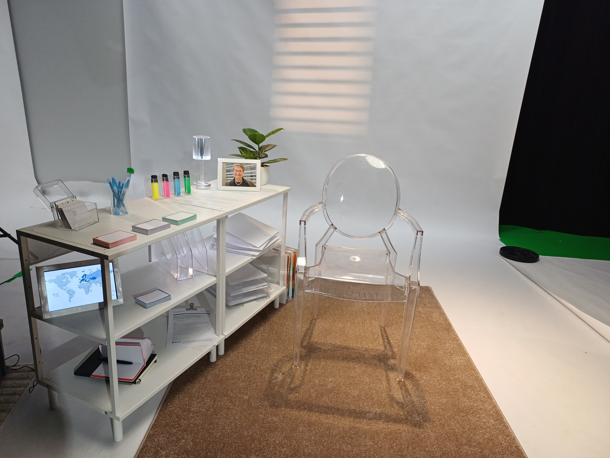White interview set with shelving, chair and props