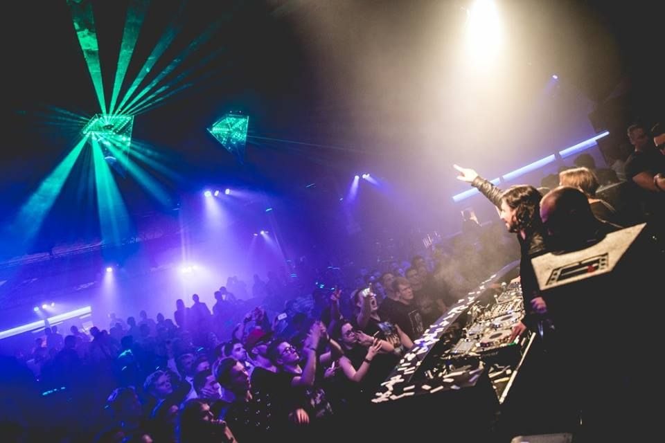 The DJ booth with audience and lasers