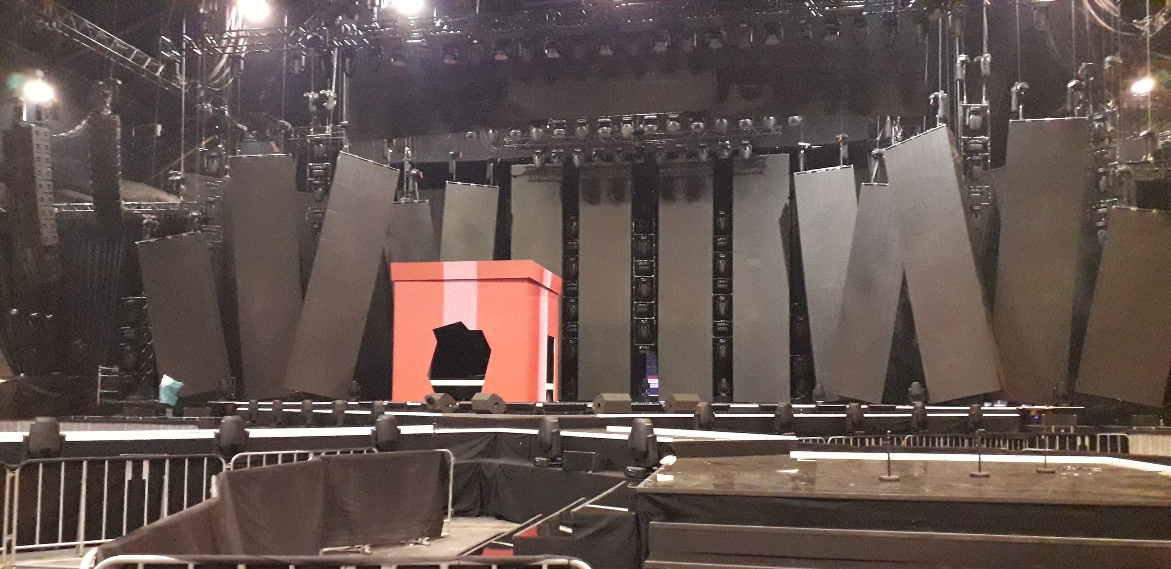 Stage set with angular panels and an orange volume